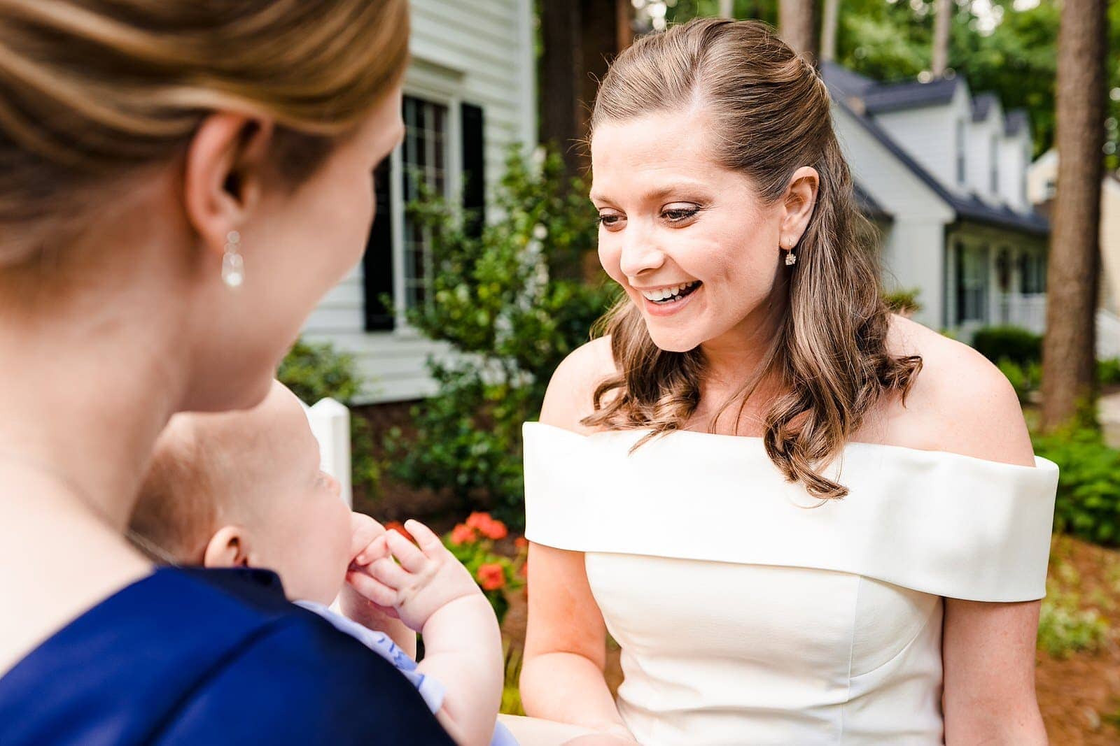 bride interacts with her baby nephew on her wedding day at a micro-wedding