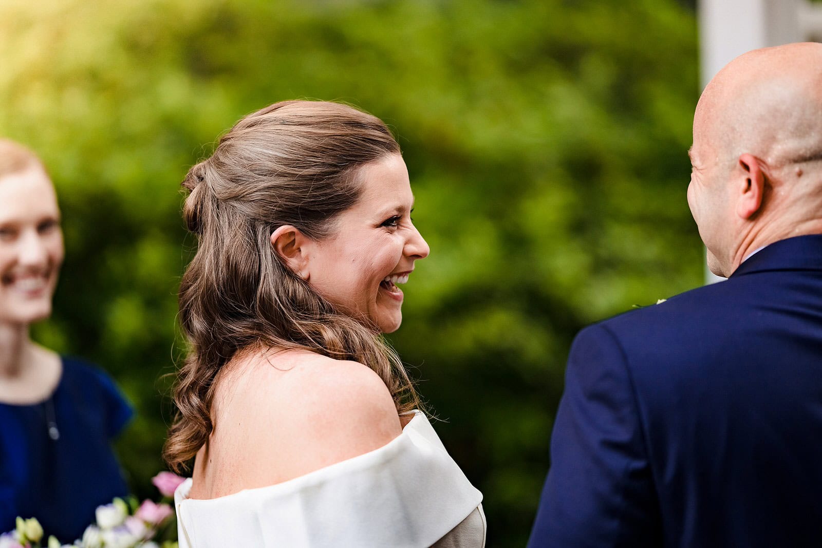 Bride laughs during wedding ceremony