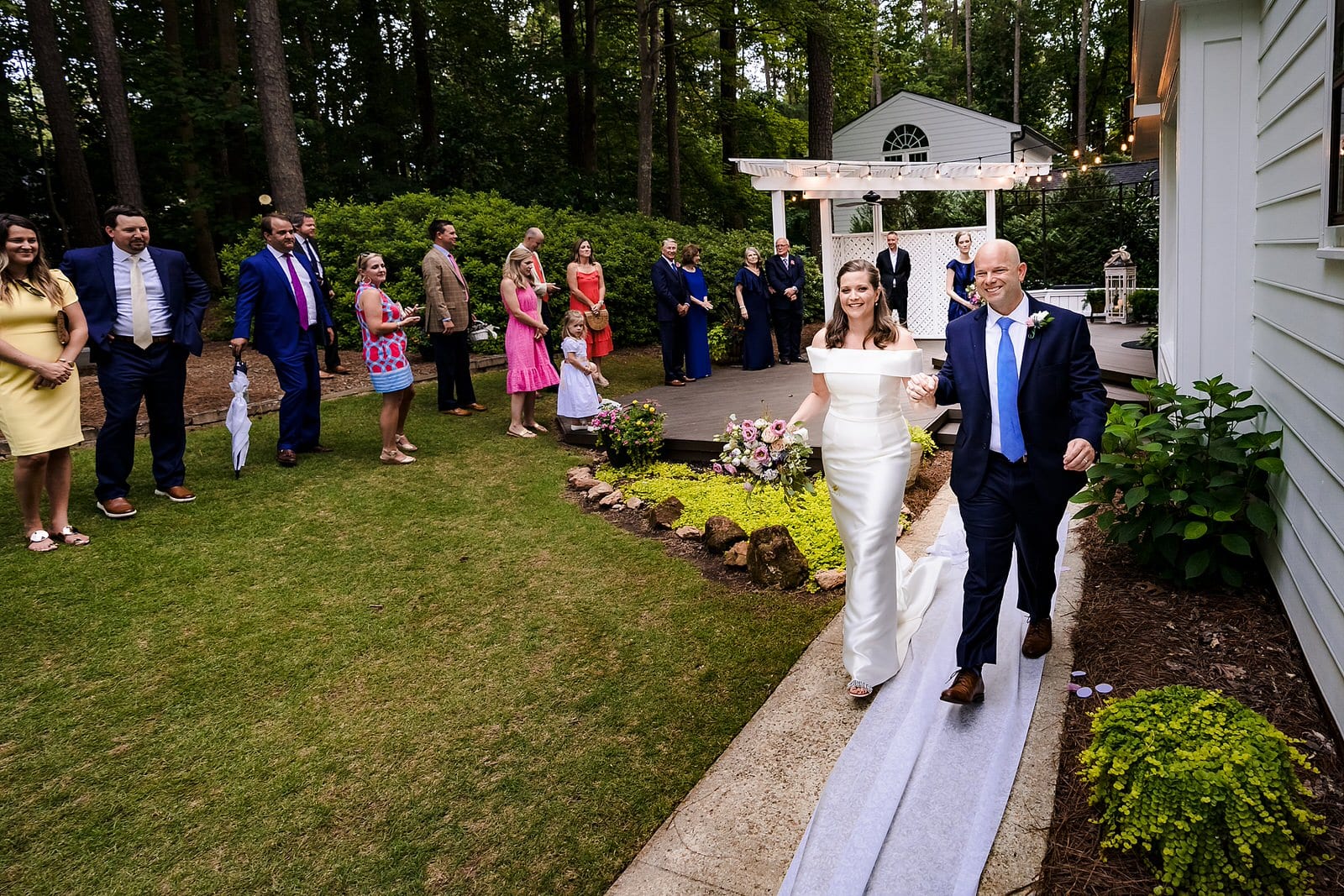 Bride and groom smile and process out of wedding ceremony at Raleigh micro-wedding