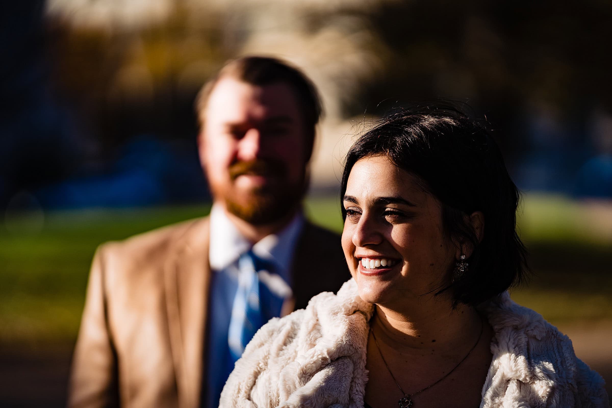 Smiling couple posing for downtown Raleigh engagement photos