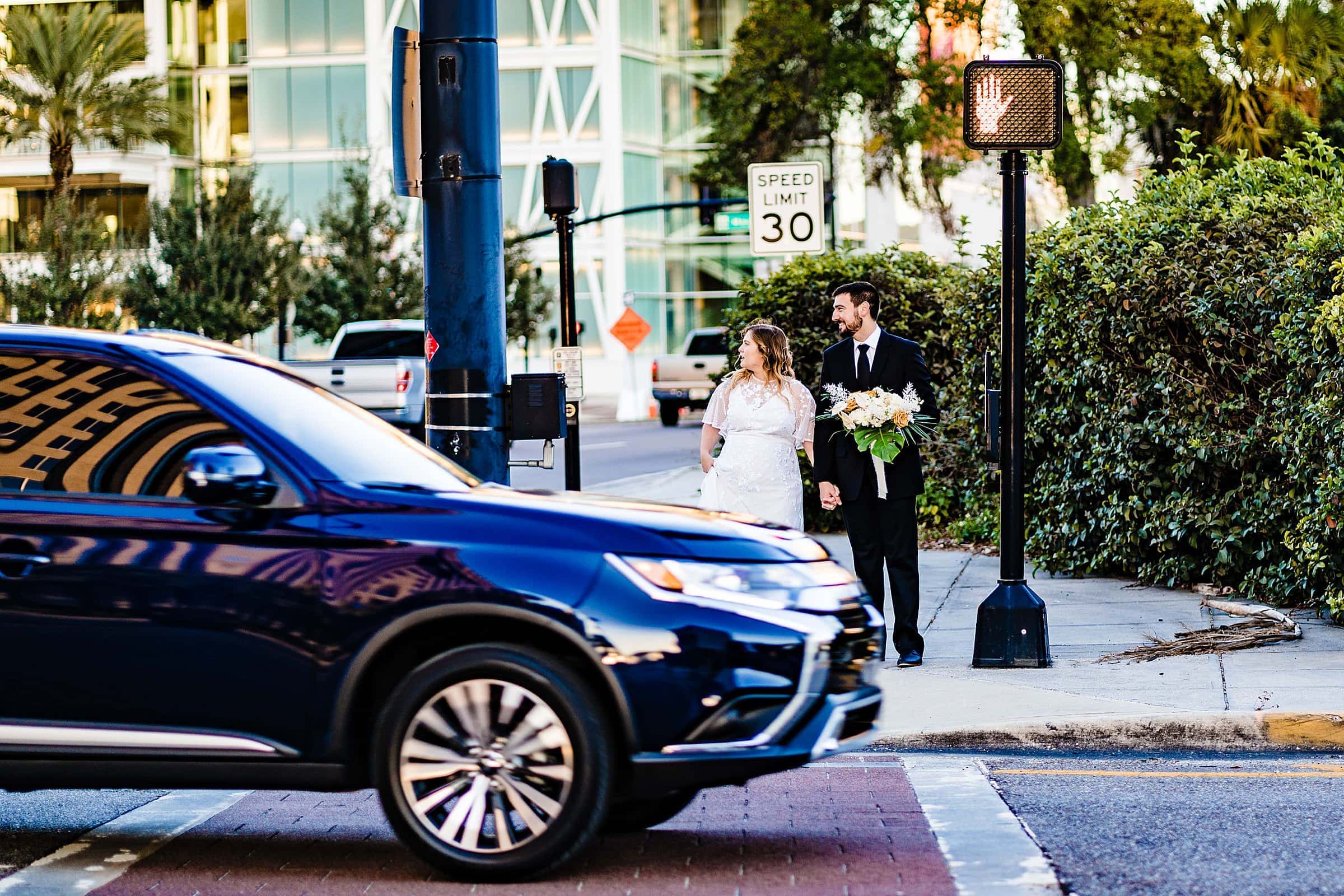 Bride and groom waiting to cross a street | kivusandcamera.com
