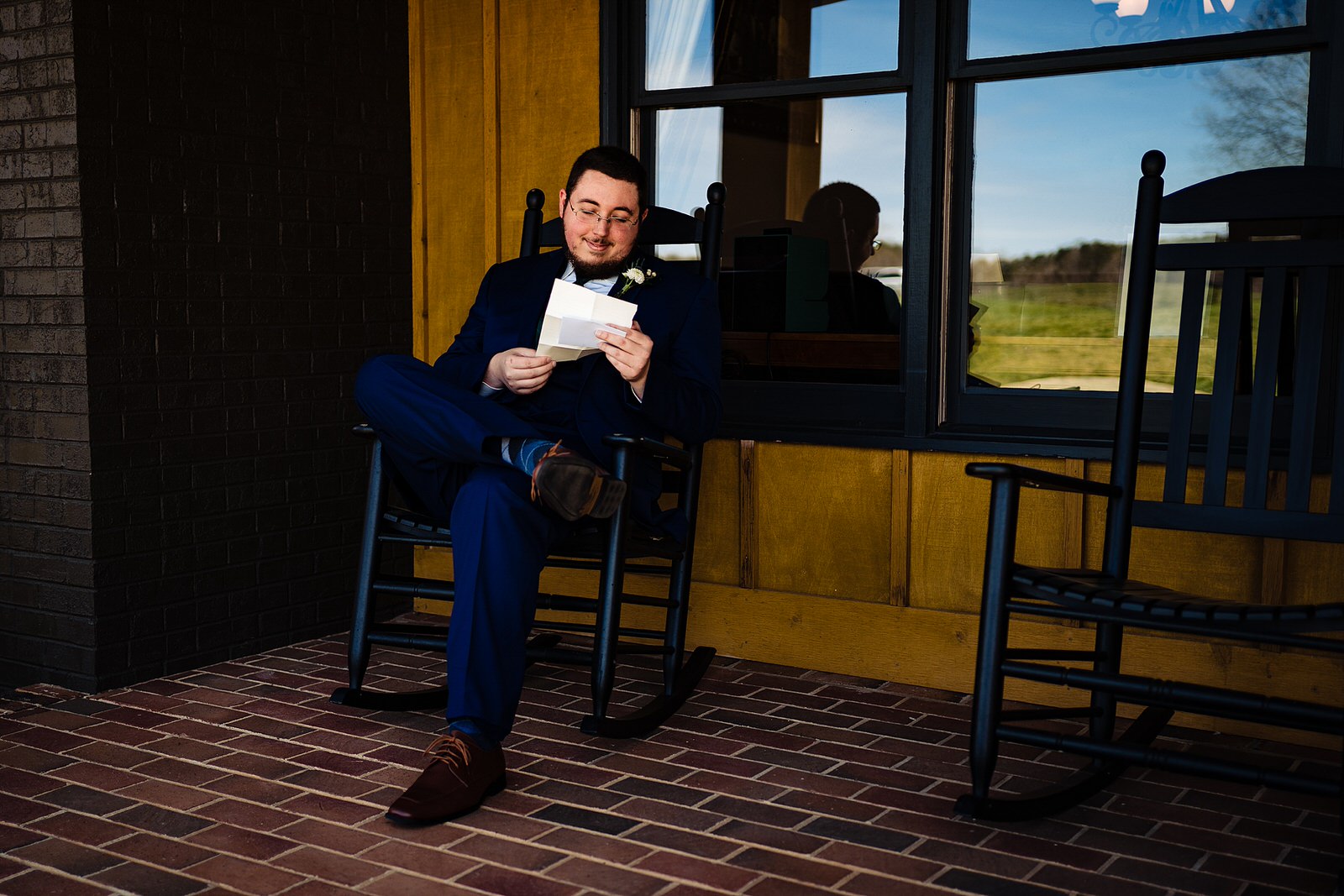 Groom reads a letter from his bride the morning of their wedding at The Meadows Raleigh