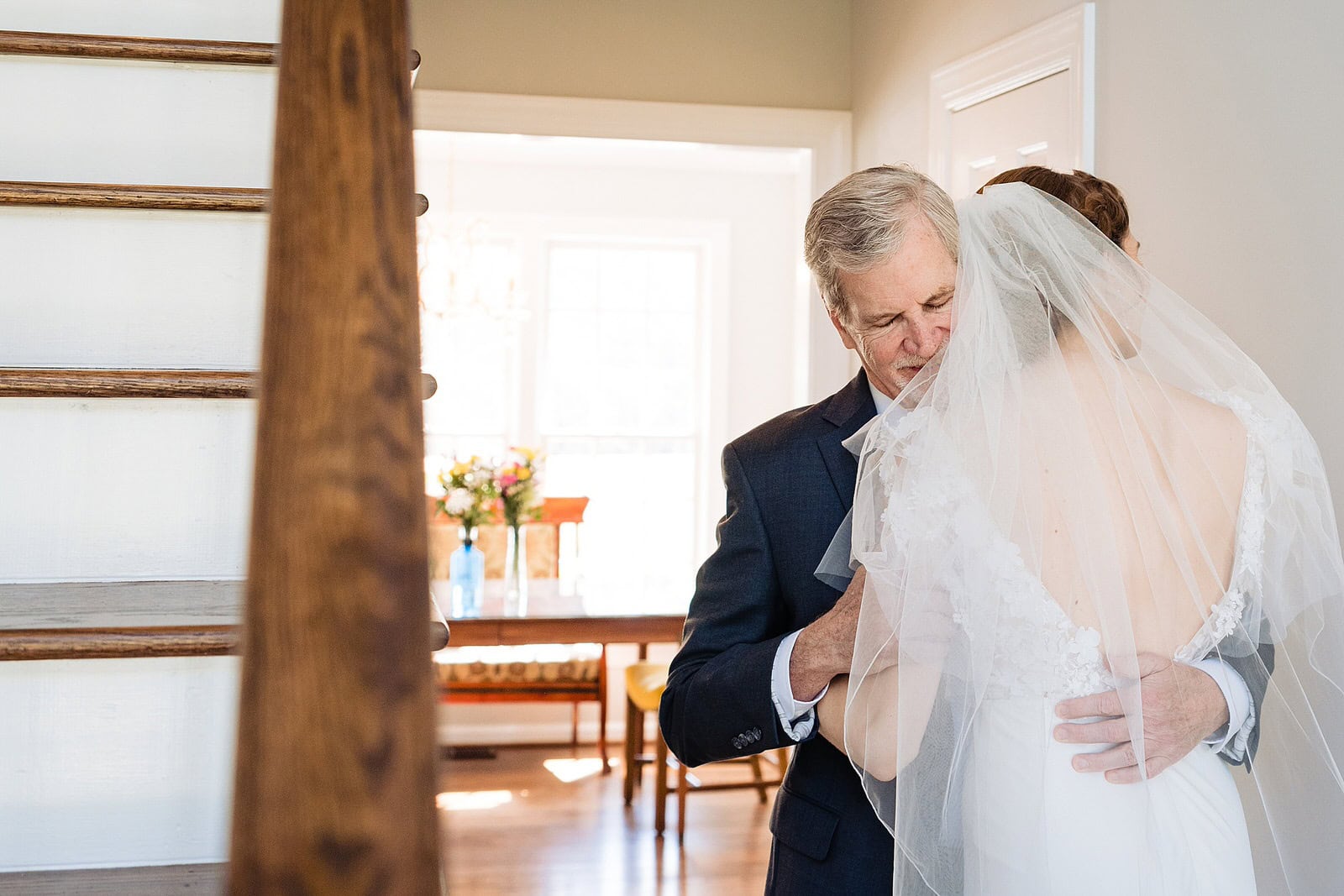 Bride and her father embrace on her wedding day at The Meadows Raleigh