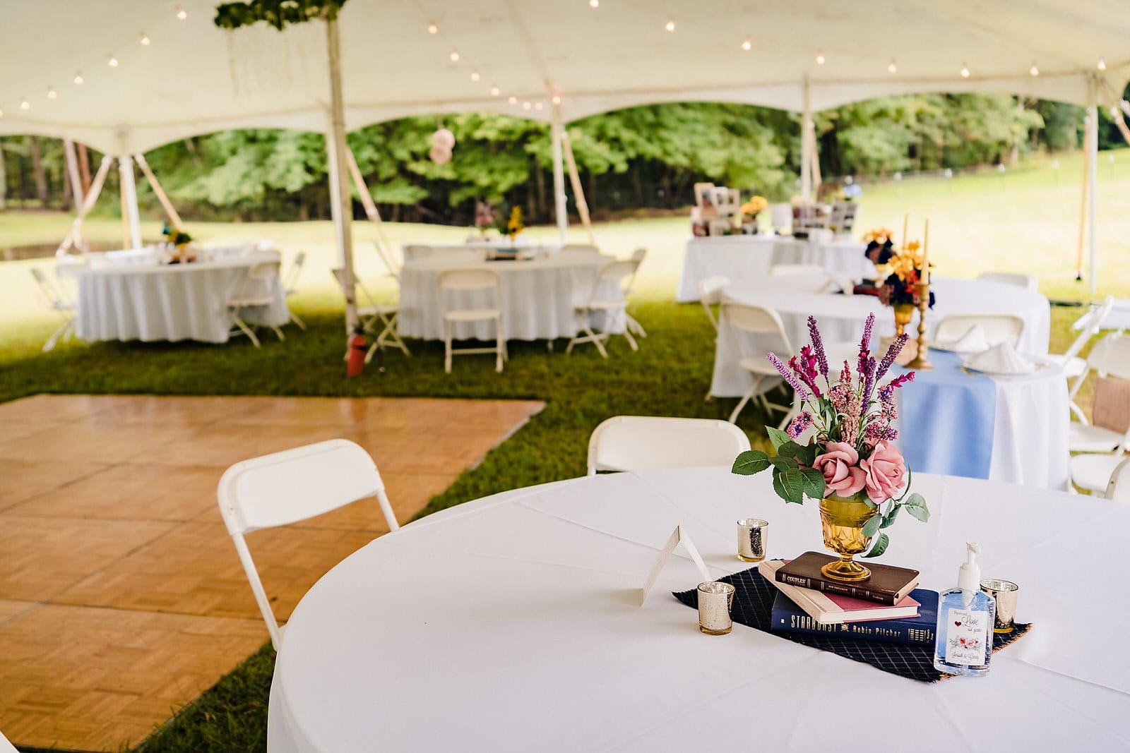 Farm wedding reception set up under at ent