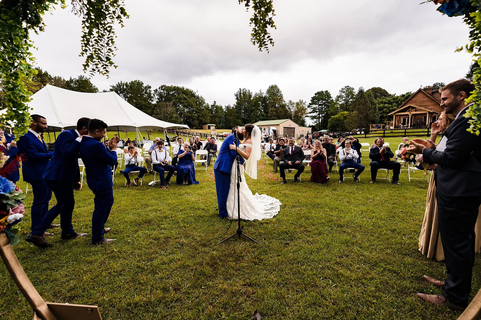 First kiss at DIY farm wedding ceremony