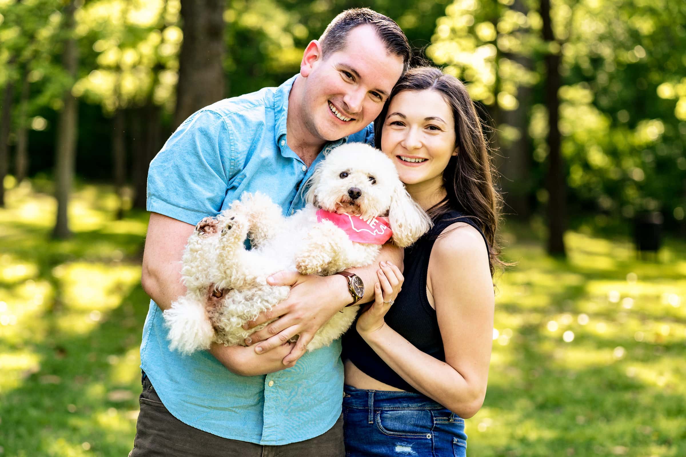 couple poses with their dog