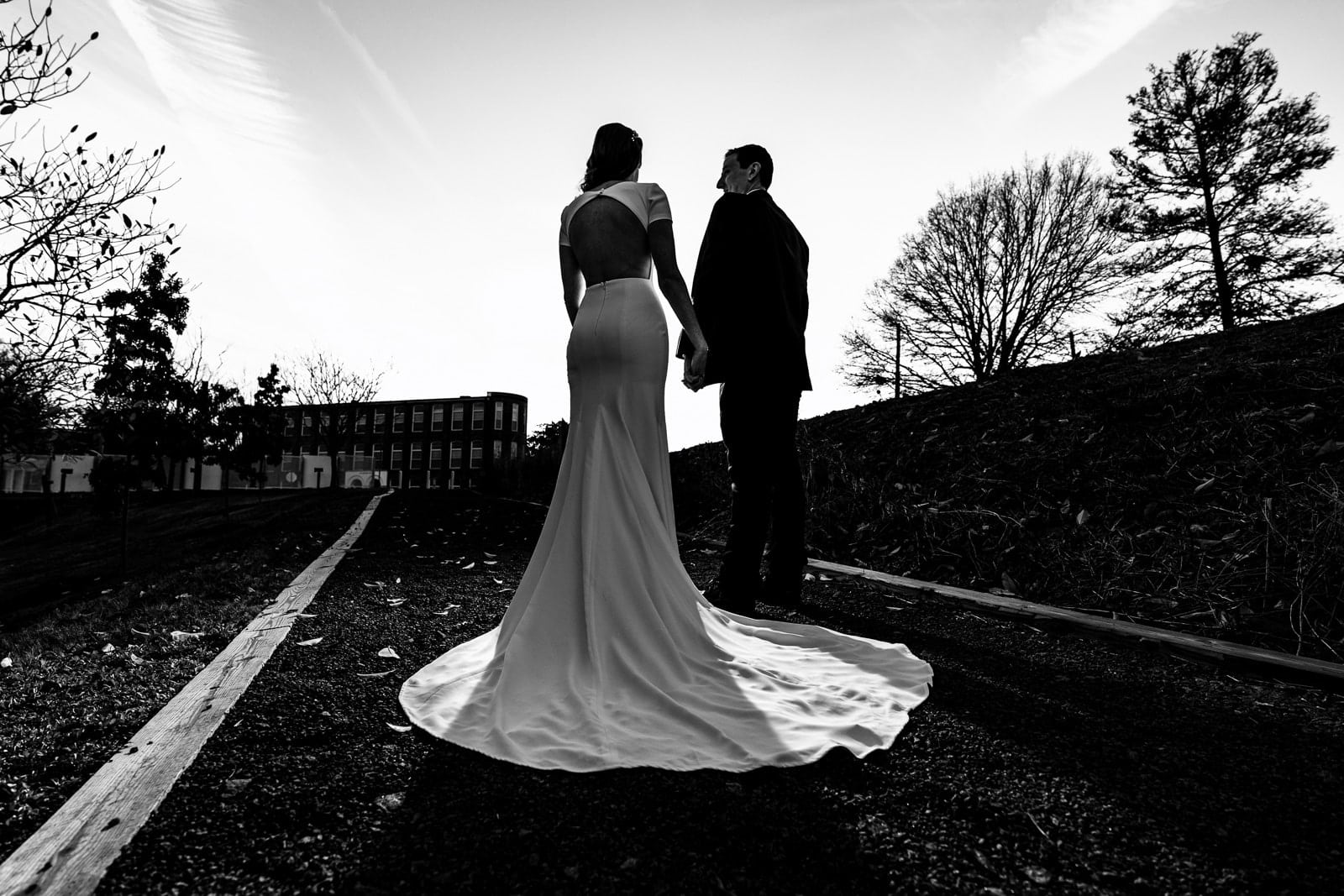 Portrait of a couple in wedding attire outside The Cotton Room wedding venue in Durham, North Carolina | photo by Kivus & Camera
