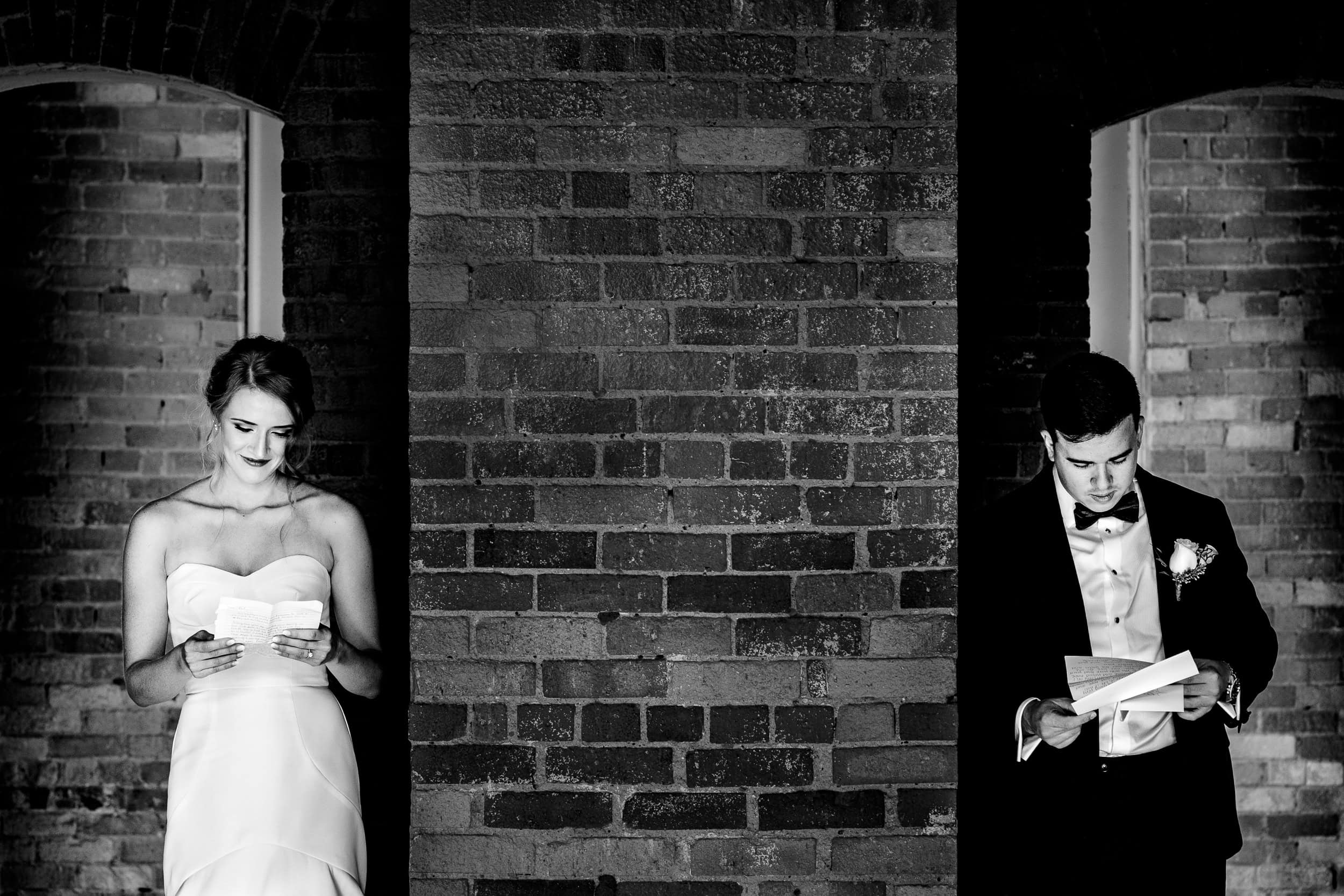 Couple in wedding attire reads letters to one another at their wedding | photo by Kivus & Camera