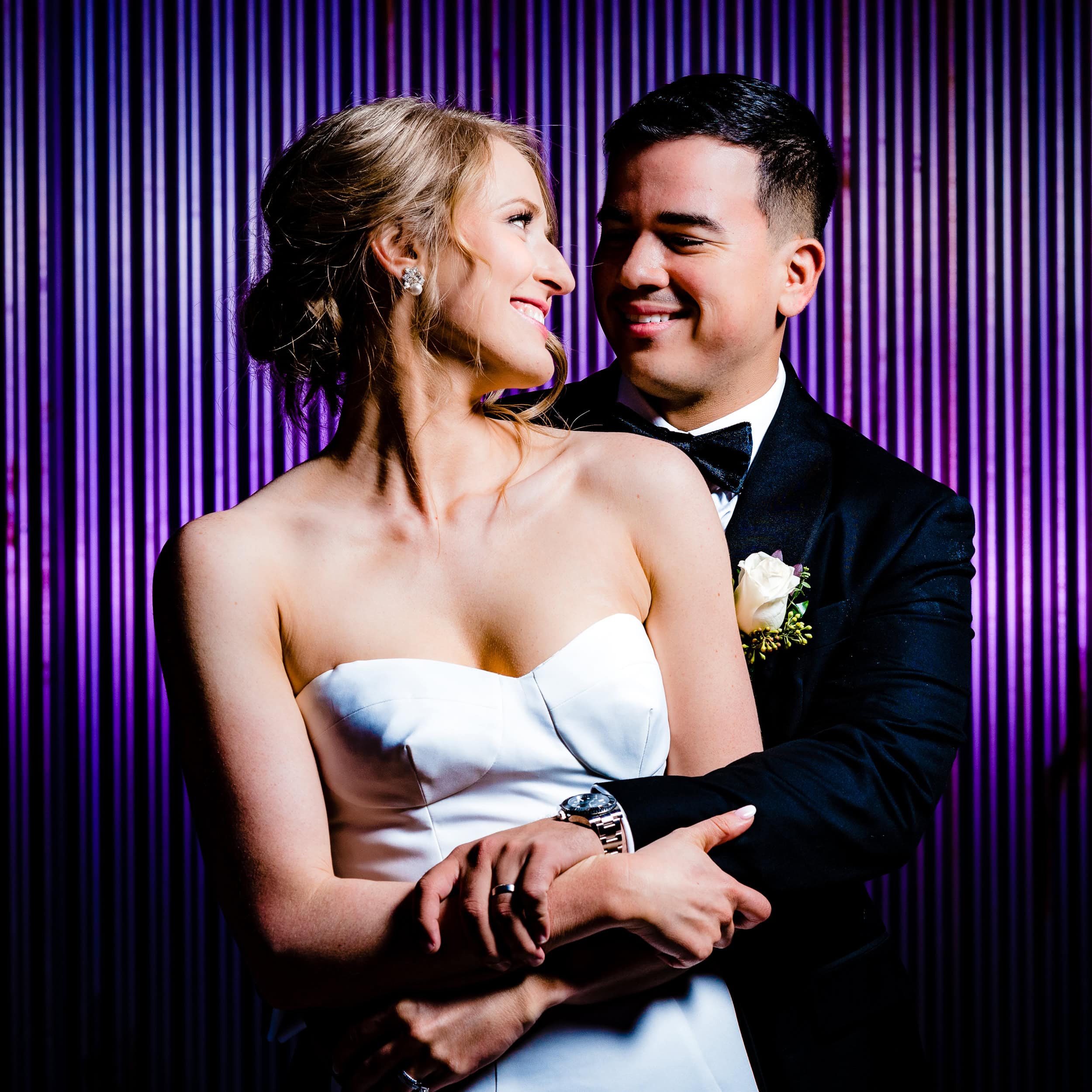 Couple in wedding attire pose for a portrait at The Cotton Room in Durham, NC | photo by Kivus & Camera
