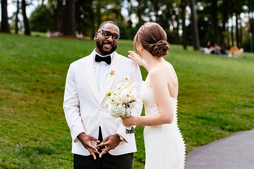 interracial couple in wedding attire shares their first look