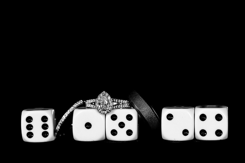 wedding rings with dice. numbers on dice show the date 6-15-24