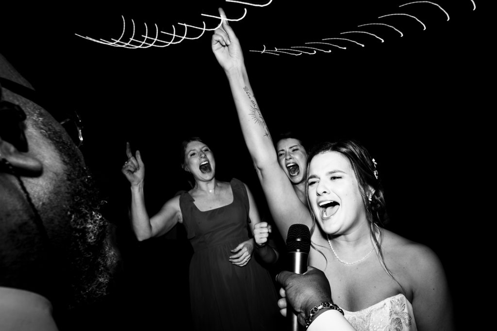 bride sings into a microphone at her Raleigh wedding