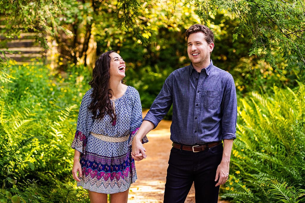 couple walks hand in hand through the NC Botanical Garden