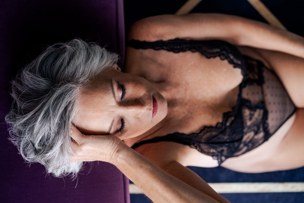 boudoir portrait of a woman with grey hair in a black lace bodysuit | photo by Triangle Boudoir