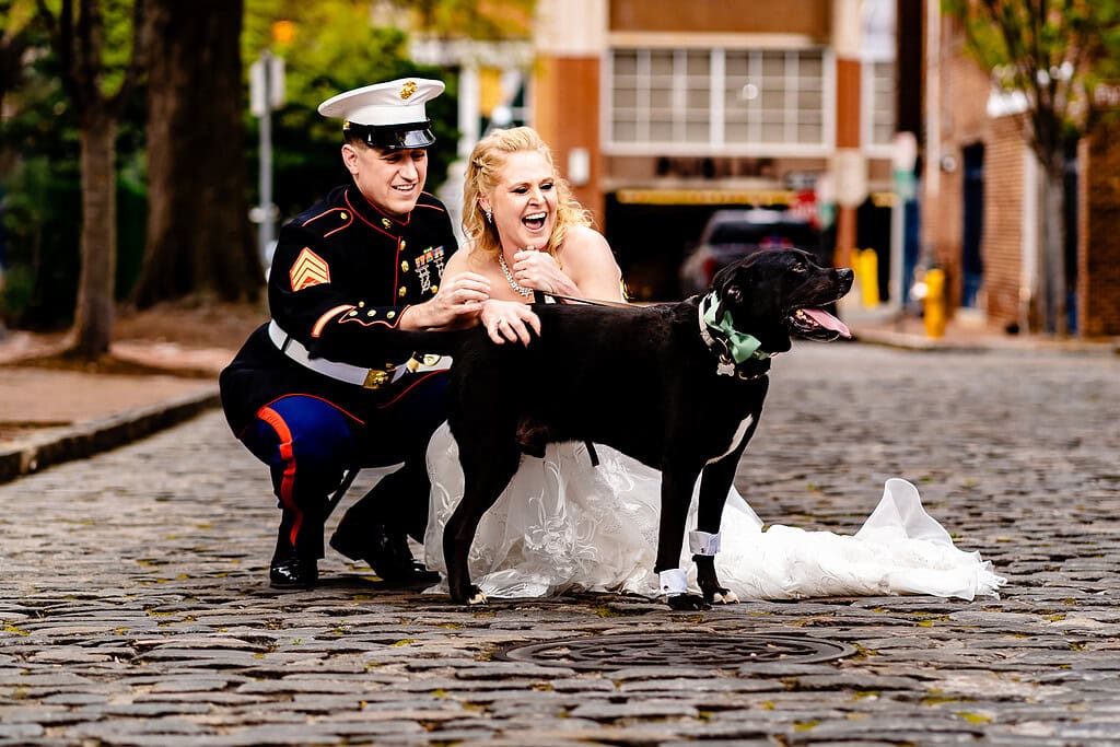 bride and groom pose with their dog