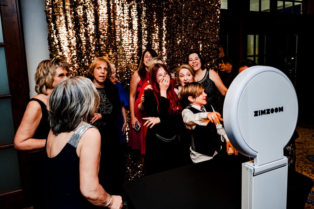 wedding guests pose for a photo in. photo booth | photo by Kivus & Camera