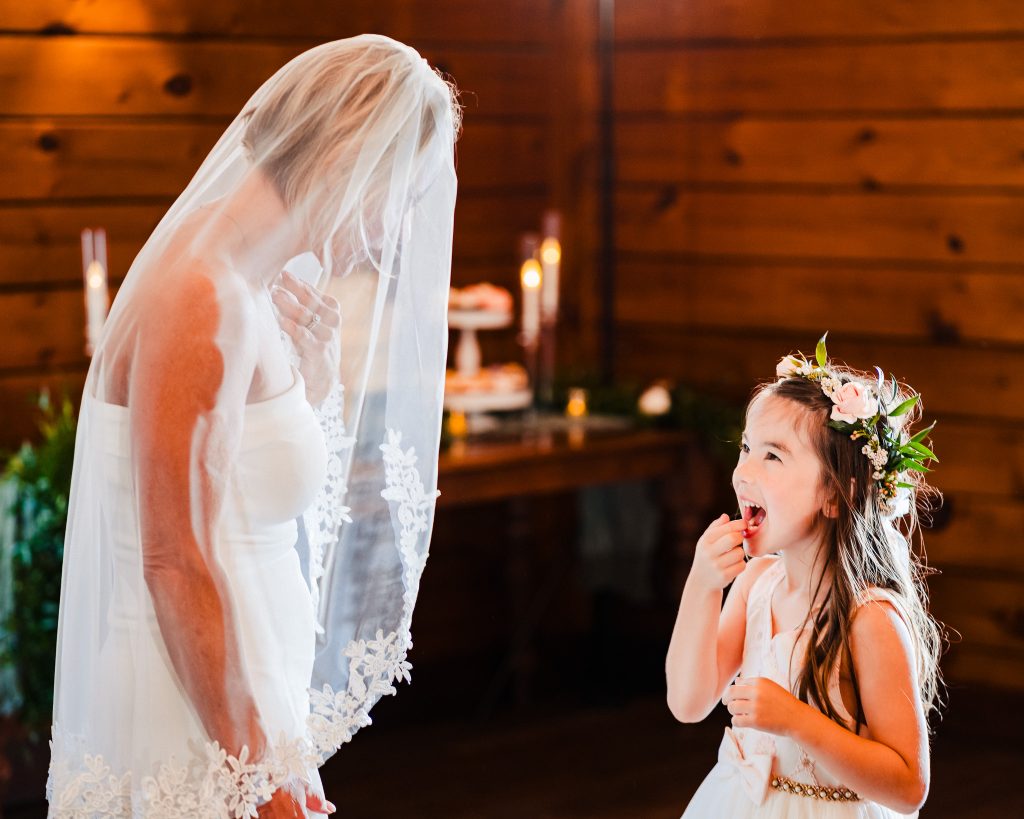 flower girl shows bride where she lost a tooth