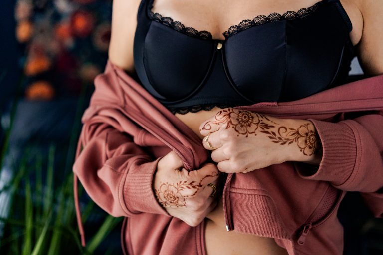 Closeup photograph of a woman's hands with henna art