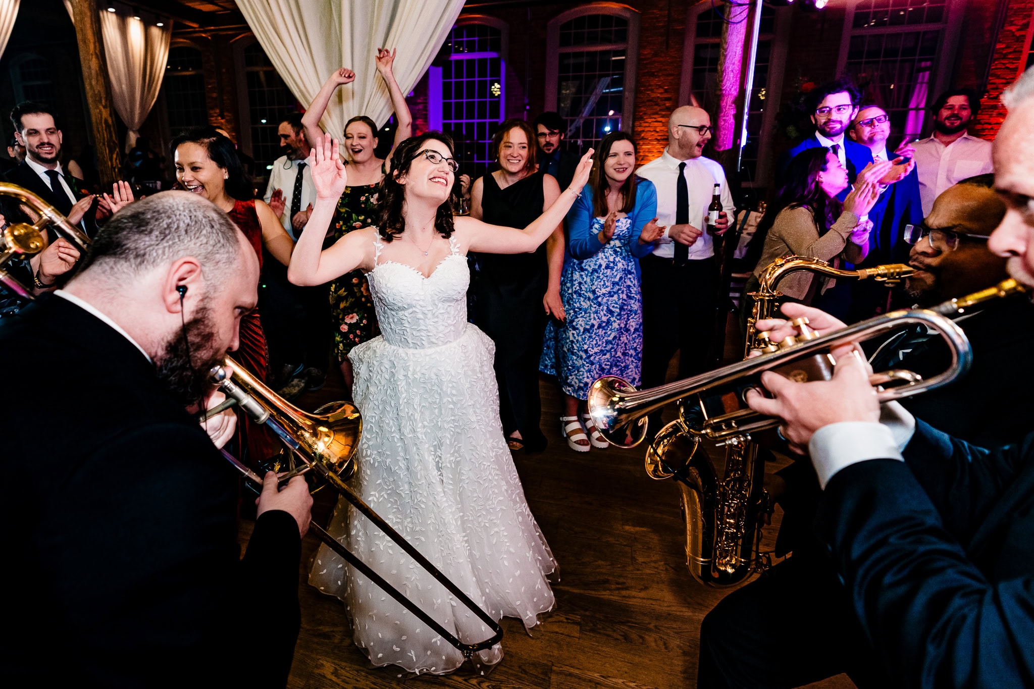 couple in wedding attire dances with a live band in the background | photo by Kivus & Camera, Durham, NC wedding photographers